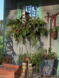 some plants are hanging on the side of a house