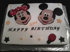 a birthday cake with two minnie mouses on it