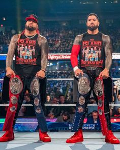 two men standing next to each other in front of a crowd with wrestling gear on