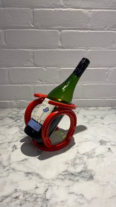 a wine bottle holder with a cell phone in it