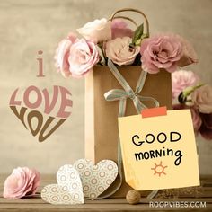 a brown bag with pink flowers and a note that says i love you good morning