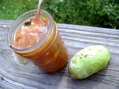 a glass jar filled with liquid next to a fruit