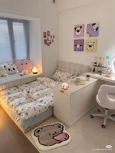 a bed room with a neatly made bed next to a white desk and computer chair