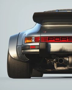 the back end of a silver porsche 914 gt3 with its exhaust pipes exposed