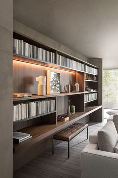 a living room filled with lots of books and furniture