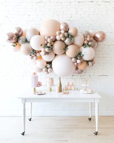 a white table topped with lots of balloons