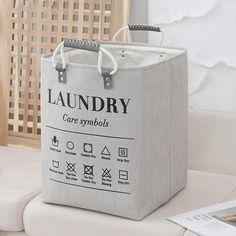 a laundry bag sitting on top of a white couch