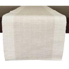 a white table runner on top of a wooden table