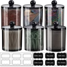 four clear canisters with black lids and labels on the bottom one is filled with noodles