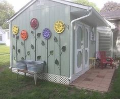 a small shed with flowers painted on the side