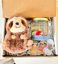 a stuffed slotty toy sitting in a box with other toys and stickers around it