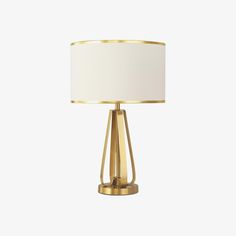 a gold table lamp with a white shade