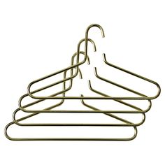 four brass metal clothes hangers on a white background