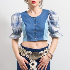 One of a kind handmade bavarian style crop top in blue with plaid puff sleeve top in printed floral pattern - buttoned down at the front - materials: denim, cotton SIZE from the tag: no tag Best fits women: M MEASUREMENTS bust: 36 inches (92 cm) length: 15.5 inches (39 cm) The model is 5'9" (174 cm), measures 35-27-38 (89-69-96 cm) and typically wears clothing in size M Fitted Cotton Crop Top With Puff Sleeves, Summer Puff Sleeve Top With Patchwork, Fitted Short Sleeve Denim Top For Fall, Trendy Fitted Short Sleeve Denim Top, Fitted Short Sleeve Denim Top With Buttons, Fitted Patchwork Crop Top For Spring, Fitted Cropped Shirt With Button Closure For Spring, Trendy Cotton Crop Top With Puff Sleeves, Fitted Plaid Puff Sleeve Blouse