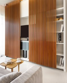 a living room with wooden slats on the wall