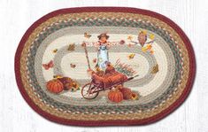 a round rug with an image of a person on a bike and autumn leaves around it