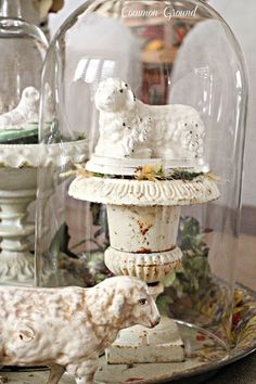 a glass clochel with figurines under it