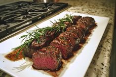 a piece of steak on a white plate with garnish