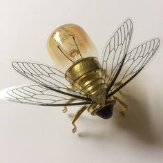 a light bulb shaped like a bee sitting on top of a table