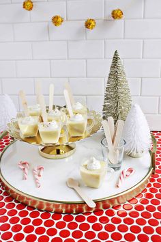 desserts are arranged on a platter with candy canes and marshmallows