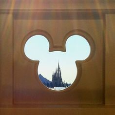 the view from inside mickey mouse's castle through a window