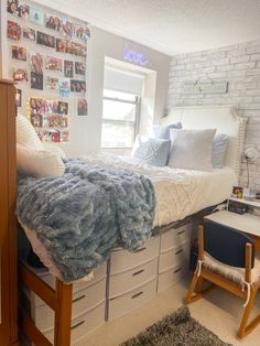 a bedroom with white brick walls and lots of pictures on the wall above the bed