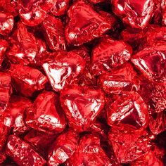 a pile of red foiled chocolate balls