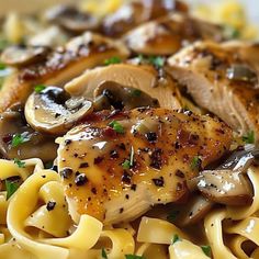 pasta with chicken, mushrooms and parmesan cheese on it