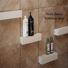 two shelves with soaps, lotion and other items on them in front of a tiled wall