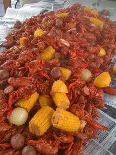 corn on the cob, potatoes and carrots are laid out to look like crawfish