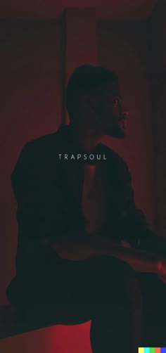 a man sitting in a dark room with the words trapsoul on it