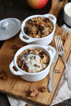 two white bowls filled with oatmeal sitting on top of a wooden cutting board