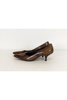 Luxe brown heels with a kitten heel and pointed toe silhouette. Great for the office, add a pencil skirt and tailored blouse to complete a work appropriate look. Size 6 (EU 36) Leather upper & synthetic sole Made in Italy Pointed toe Kitten heel Slip on Light outsole wear Scuff on front of left toe Heel height 2.5" Brown Heels, Pointed Toe Heels, Cheap Shoes, A Pencil, Kitten Heel, Kitten Heels, Pencil Skirt, Prada, Heel Height