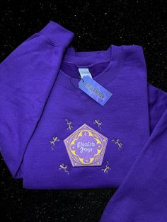 Chocolate Frogs Embroidery Sweater  Handmade Color: Purple  Adult Unisex Sizes S-XL Very soft and cozy crewneck <3 Chocolate Frogs Harry Potter, Nerdy Clothes, Sweata Weatha, Chocolate Frogs, Chocolate Frog, Purple Sweatshirt, Embroidery Sweater, Embroidery Hoodie, Embroidery Sweatshirt