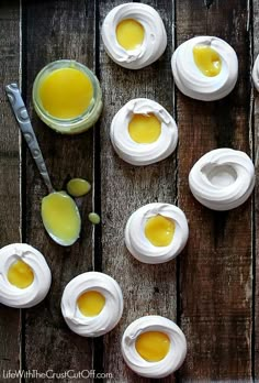 several small jars filled with different types of creams on top of a wooden table