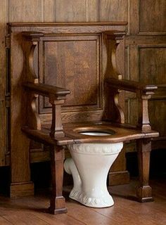 a toilet in a room with wooden paneling