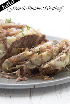 a close up of a plate of food with meat and cheese on it's side