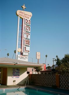 an old motel with a swimming pool in the foreground