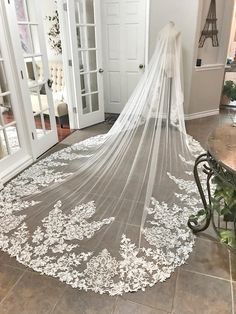 a white wedding veil is on the floor