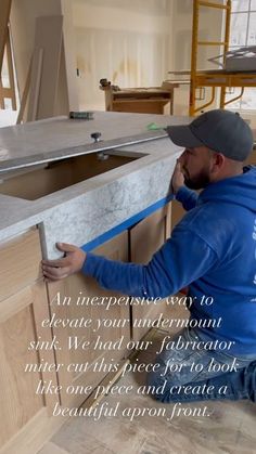 a man working on a kitchen counter with the words, an appliance way to execute your interior