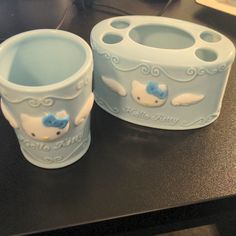 two ceramic cups sitting on top of a counter