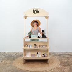 a woman standing in front of a stand with cosmetics on it