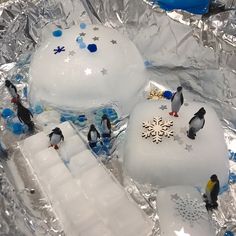 penguins and snowflakes are on top of an ice sculpture