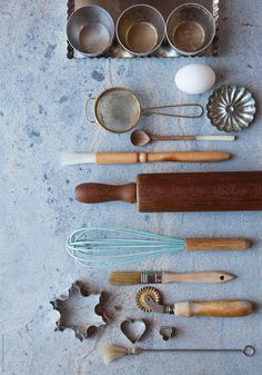 an assortment of kitchen utensils laid out on a table