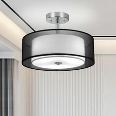 a black and white lamp hanging from the ceiling