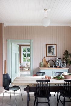 a dining room table with four chairs around it