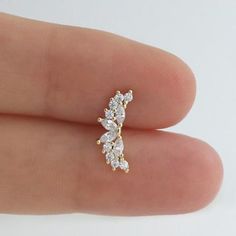 a close up of a person's finger wearing a ring with three diamonds on it