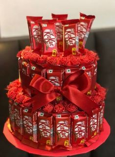 a cake made out of candy bars with red ribbons