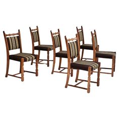 six wooden chairs with striped upholstered seats