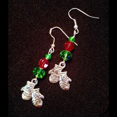 Fun Christmas And Winter Earrings Feature Paired, Zigzag Patterned Mitten Tibetan Silver Charms Accented By Green And Red Crystal Beads. Earring Length Including Silver Alloy Hooks 2.25". Charms Measure Approx 18 X 15mm. Largest Beads, Green Rondelles Measure 8mm. V/I 12/24 Handmade Green Beaded Earrings For Holiday, Handmade Green Earrings For Holidays, Holiday Green Handmade Earrings, Christmas Green Earrings With Dangling Beads, Green Christmas Drop Earrings Jewelry, Black Heart Earrings, Winter Earrings, Peridot Crystal, Bamboo Earrings